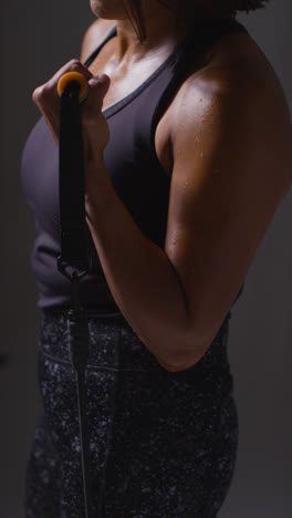 Vertical-Video-Close-Up-Shot-Of-Mature-Woman-Wearing-Gym-Fitness-Clothing-Exercising-With-Resistance-Band